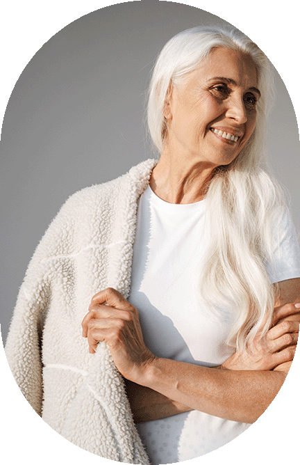 woman holding a cozy jacket around her shoulders