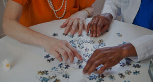 two seniors doing a puzzle together