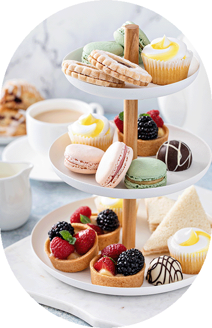 stacked plate stand with sandwiches, tartlets and macarons