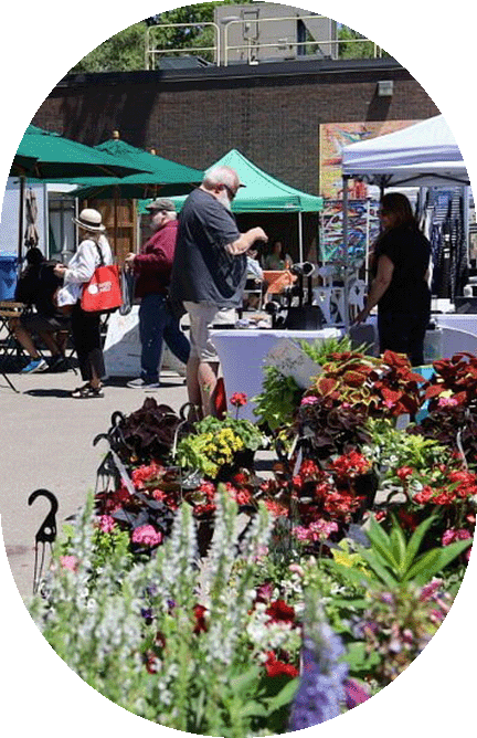 outdoor market flowers in forground and people in background