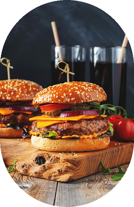 close up of two hamburgers with lots of toppings