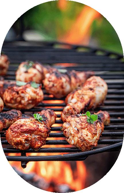 close up of chicken grilling on a charcoal bbq
