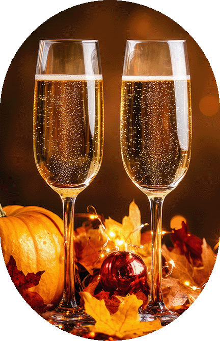 two glasses of champagne with fall leaves and red ornaments