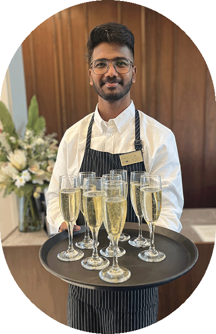 Waiter serving champagne on tray