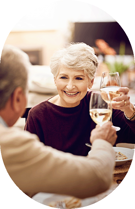 Elderly couple toasting with glasses