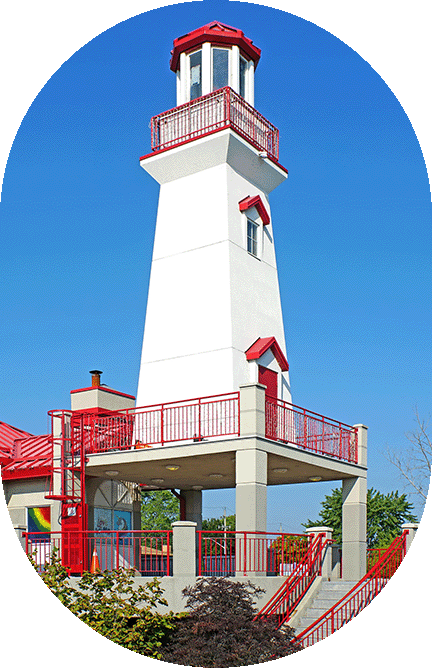 Red and white lighthouse against blue sky